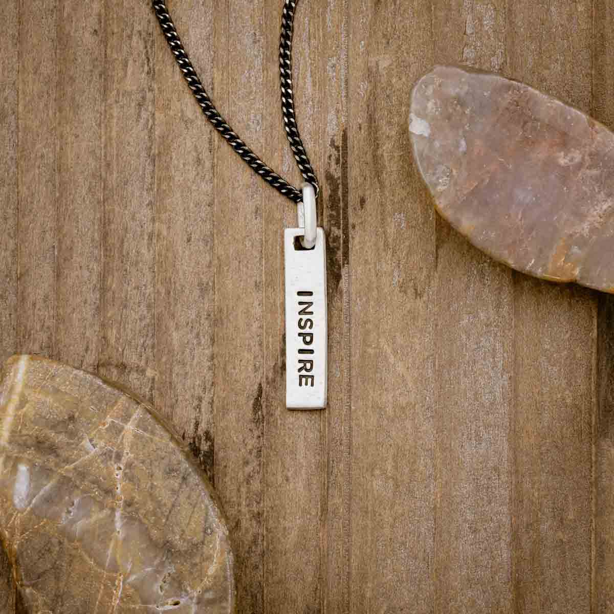 sterling silver Kairos Necklace with personalization, on wood background