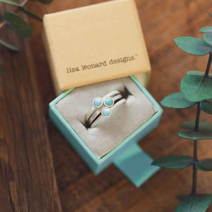 girl stacking two sterling silver Lighthearted Turquoise Rings on her finger