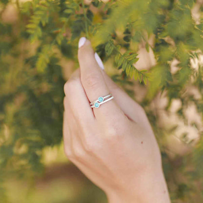 girl stacking two sterling silver Lighthearted Turquoise Rings on her finger