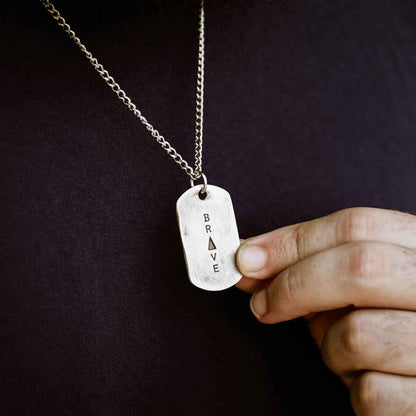 man wearing a Live Brave Dog Tag Necklace handcrafted in pewter