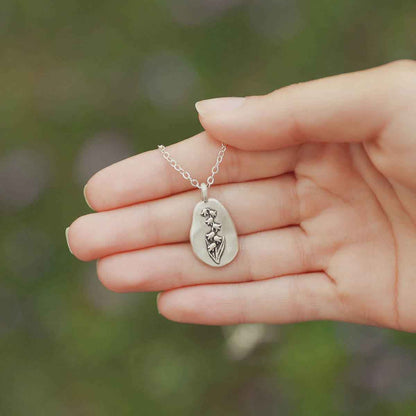 girl wearing a sterling silver May Birth flower necklace