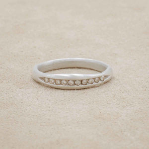 Passage ring handcrafted in 10k white gold and display of 1.5mm cubic zirconias