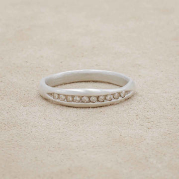 Passage ring handcrafted in 10k white gold and display of 1.5mm cubic zirconias