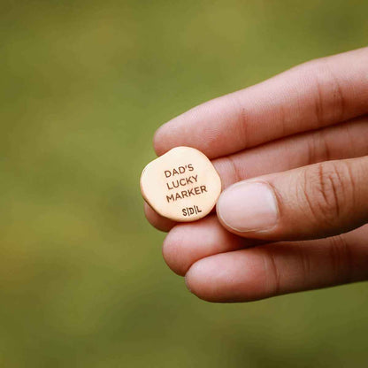 hand holding personalized Bronze Roman Cross Coin Golf Ball Marker