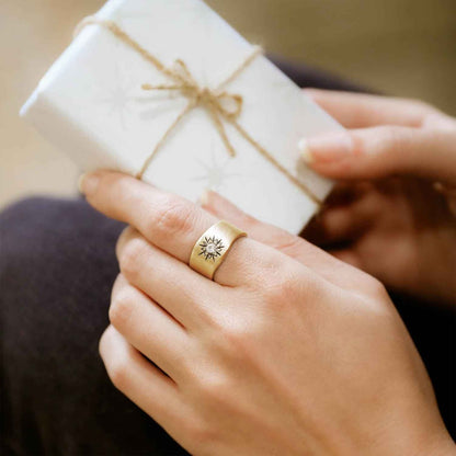 Girl wearing Sunburst birthstone ring handcrafted in 10k yellow gold and set with a birthstone of your choice